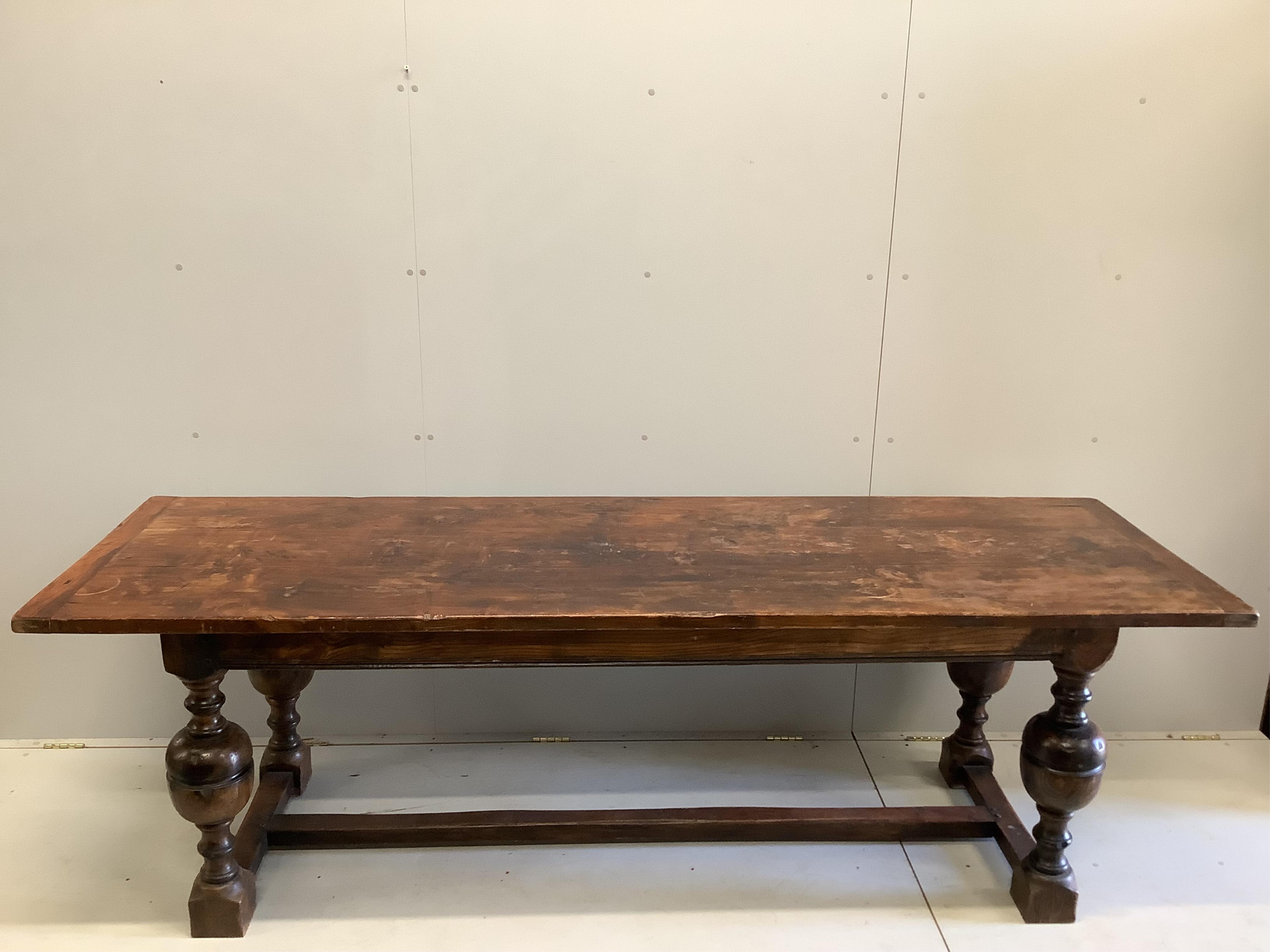 A 17th century style rectangular oak refectory dining table, width 242cm, depth 77cm, height 76cm. Condition - fair